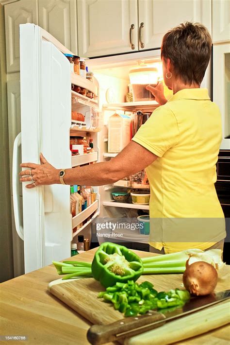 Woman Using Refrigerator High Res Stock Photo Getty Images