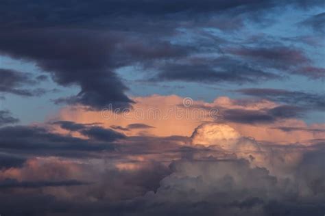 Dramatic Colorful Storm Cumulus Clouds At Sunset Against Blue Sky Stock