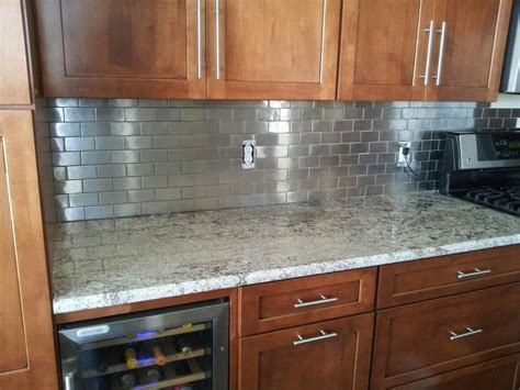 To install a stainless steel backsplash, you need various tools, such as a caulking gun, a putty knife, construction adhesive, kraft paper and sandpaper. Stainless Steel tile backsplash. - Yelp