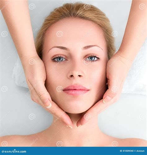Young Woman In Spa Gets A Facial Massage Stock Photo Image Of Lovely