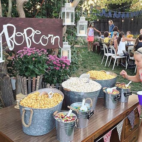 A Rustic Popcorn Bar With Buckets And Bathtubs With Popcorn And