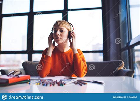 Young Designer Listening To Music Working On New Project Stock Photo