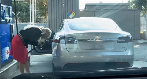 woman hilariously tries to fill up tesla model s with gas carscoops