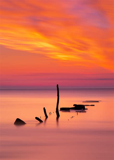 Ocean Sunset Sticks Horizon Hd Phone Wallpaper Peakpx