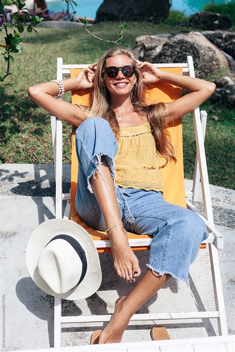 Happy Blonde Woman Have Fun In Sun Lounger By Stocksy Contributor Viktor Solomin Stocksy