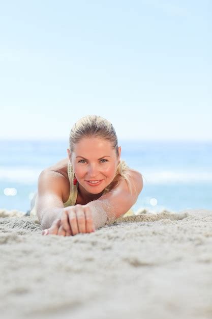 Premium Photo A Woman Sunbathing At The Beach
