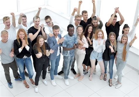Large Group Of Serious Young People Standing Together Stock Image