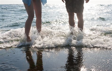 Legs Of Two People Standing In The Sea Foam Legs Of Two Pe Flickr
