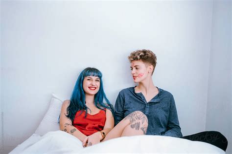 A Couple Of Lesbians In Bed Leave Lipstick Marks On Their Faces Del Colaborador De Stocksy