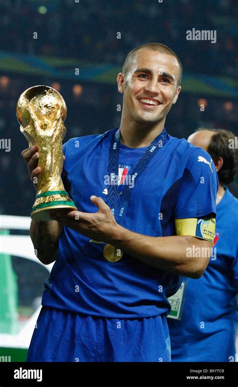 Italy Team Captain Fabio Cannavaro Holds The World Cup Trophy After