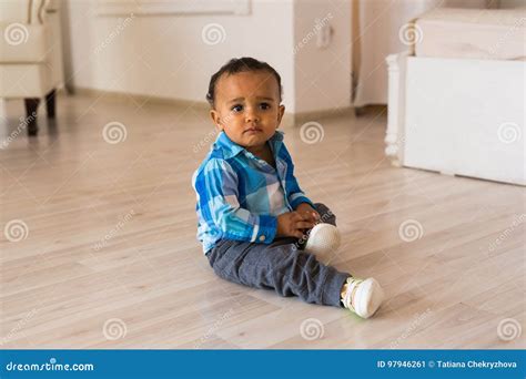 Small Child Tries To Put On His Shoes Mixed Race Baby Boy With Shoes