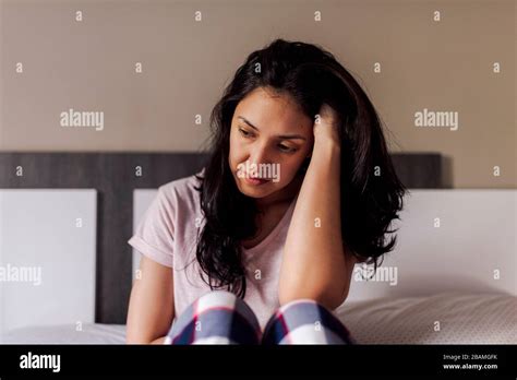 Sad Young Woman Sitting Alone In Bed In A Room Concept Of Dramatic