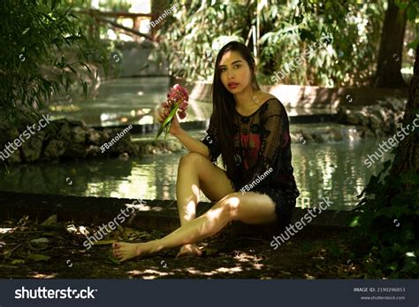 Venezuelan Brunette Girl Bikini Park Leaning Stock Photo