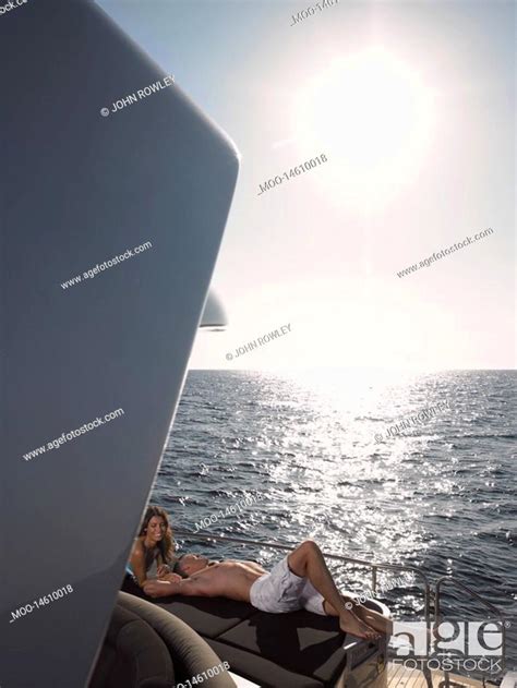 Couple Sunbathing On Boat Stock Photo Picture And Royalty Free Image