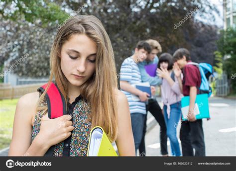 Unhappy Girl Being Gossiped About By School Friends Stock Photo By