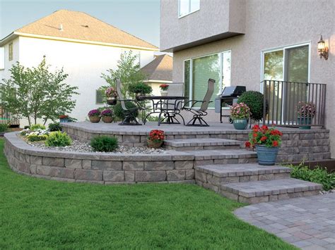 A Raised Patio Featuring The Highland Stone Retaining Wall