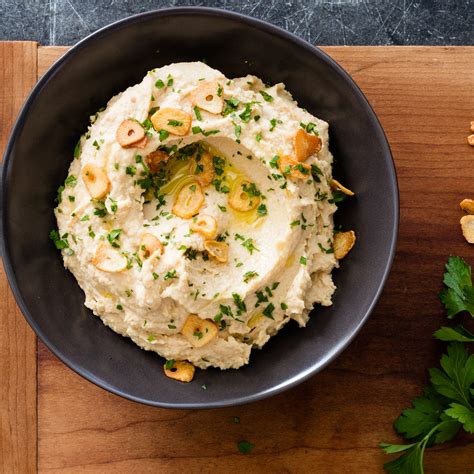 This roasted garlic hummus recipe is perfect for those who don't care for the tahini taste in hummus. Roasted Garlic Hummus | Cook's Illustrated
