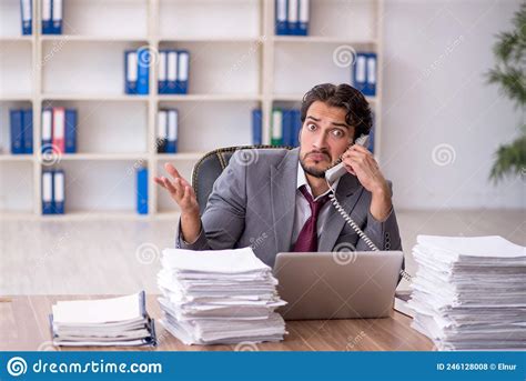 Young Male Employee And Too Much Work In The Office Stock Photo Image