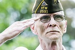 U.S. Army veteran Joe Cochran salutes the American flag during a wreath ...