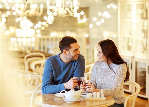 Happy Couple Drinking Tea At Cafe Stock Photo Image Of Festive