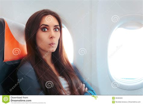 Funny Surprised Woman Sitting By The Window On An Airplane Stock Image