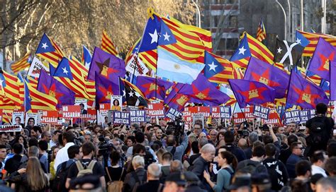 Castilian And Catalan Separatist Flags Being Flown In A Manifestation For