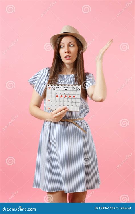 Portrait Of Pensive Woman In Blue Dress Hat Holding Periods Calendar