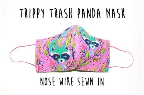 A Pink Mask With A Raccoon Face On It That Says Trappy Trash Panda
