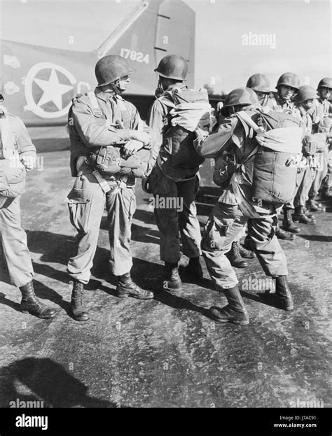 Us Paratroopers Inspecting Each Others Parachutes Before Taking Off