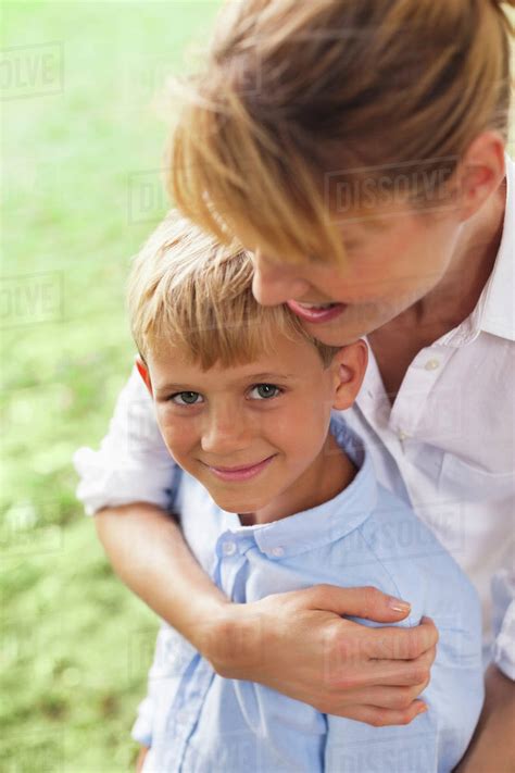 Mother Hugging Son In Park Stock Photo Dissolve
