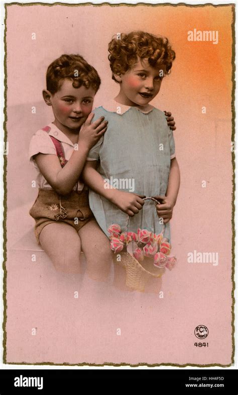 Two Eastern French Siblings One Holding A Floral Basket Stock Photo