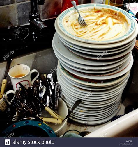 Download the perfect dirty kitchen pictures. Large pile of dirty washing up in the kitchen sink Stock ...