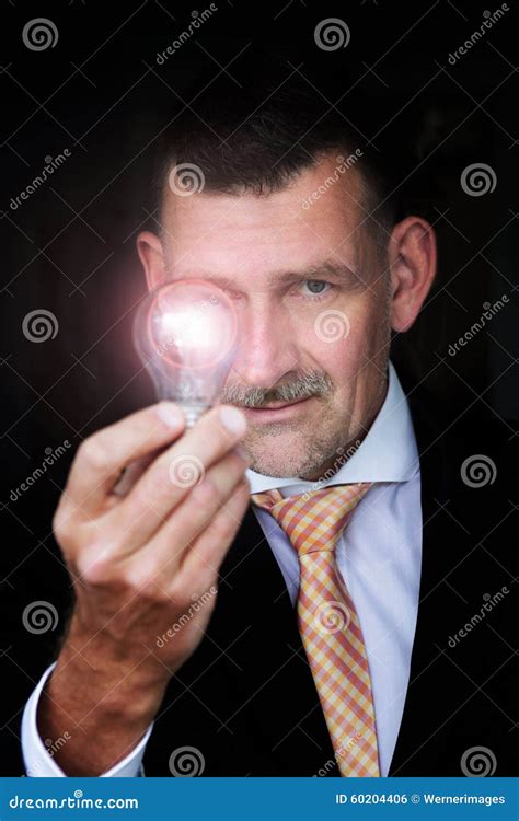 Man Holding A Lightbulb Stock Photo Image Of Leadership 60204406