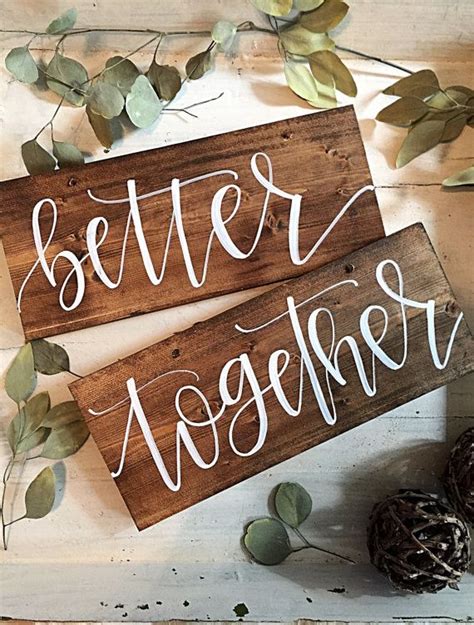 Two Wooden Signs That Say Better Together On Top Of A Table Next To