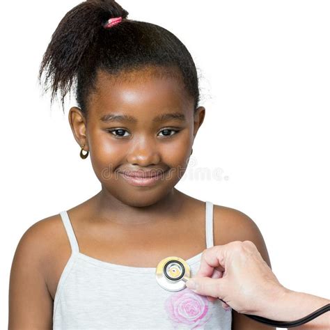 African American Female Doctor Examining Girl Stock Photo