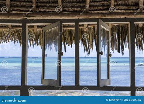 Open Windows Of Thatched Roof Veranda Overlooking The Turquoise Ocean