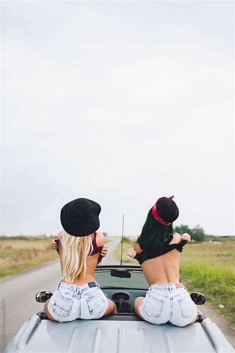 Group Of Happy Female Friends Enjoying Road Trip In Their Cabriolet By Stocksy Contributor