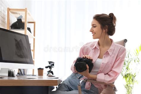 Professional Photographer With Camera Working At Table Stock Photo