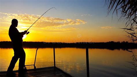 Young Man Fishing On A Lake At Sunset Stock Photo Image Of Background