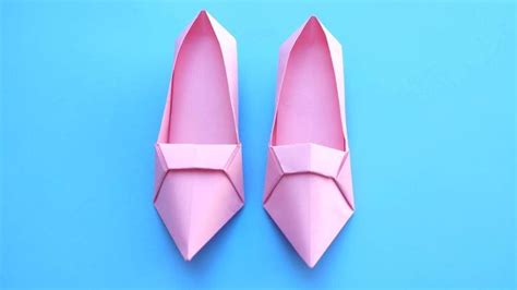 A Pair Of Pink Ballet Shoes Sitting On Top Of A Blue Surface With The