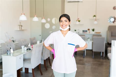 Self Assured Salon Worker Smiling In Uniform Spa Clinic