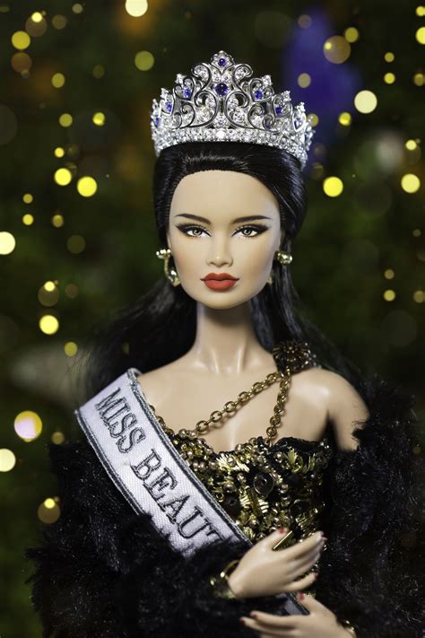 A Barbie Doll Wearing A Tiara And Dress In Front Of A Christmas Tree