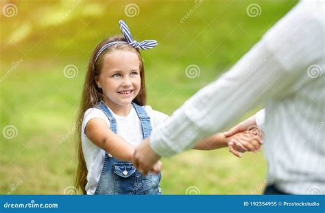 Daughter And Mother Holding Hands Spinning Around In Park Cropped Stock Image Image Of