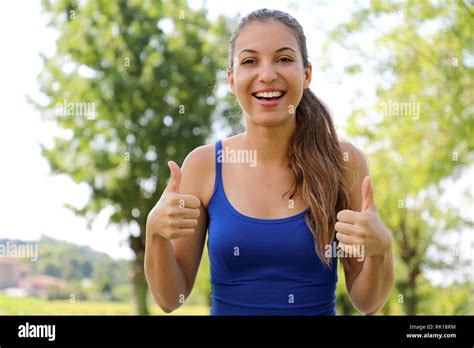 Portrait Of Winning Girl Showing Thumbs Up Positive Smiling Fitness Woman Outdoor Stock Photo