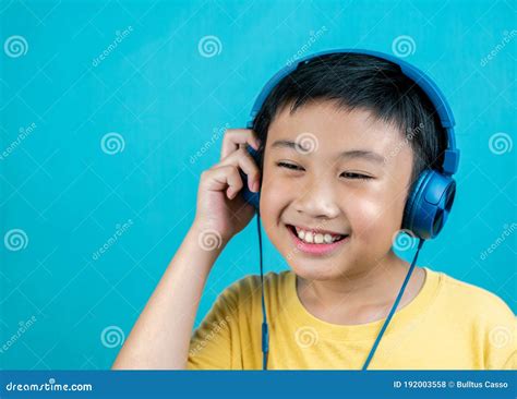 Little Boy Listening To Music On Blue Background Stock Photo Image Of