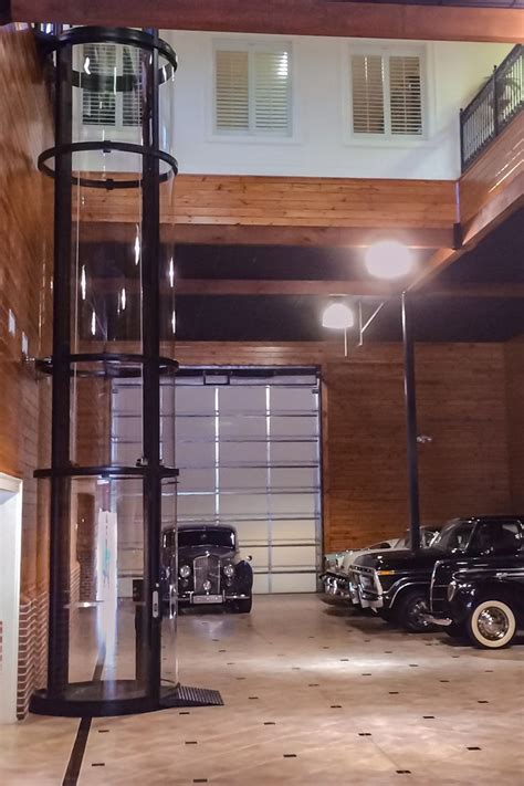 Dream Garage With Tall Vuelift Round Installation Glass Elevator