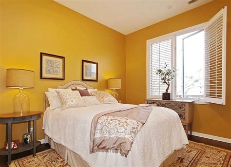 A Bedroom With Yellow Walls And White Bedding