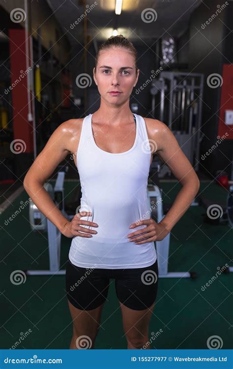 female athletic standing with hands on hip in fitness center stock image image of motivation