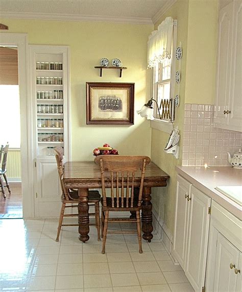 Modern kitchen with brick wall. Yellow vintage 1920s kitchen, spice rack built into the ...