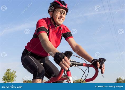 Smiling Professional Road Cyclist During Ride On Bike Outdoors Stock